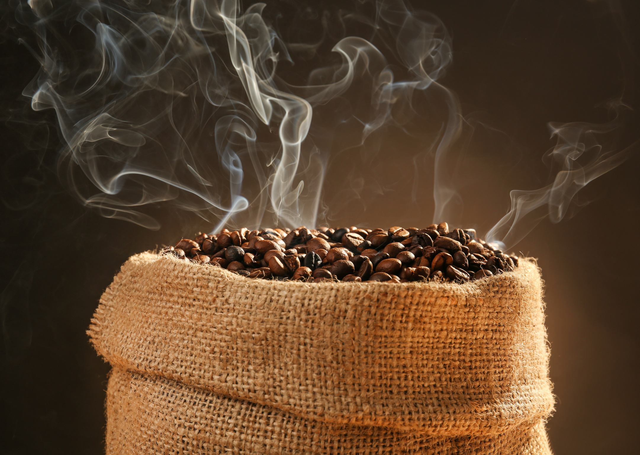 Sack of Coffee Beans with Smoke on Dark Background